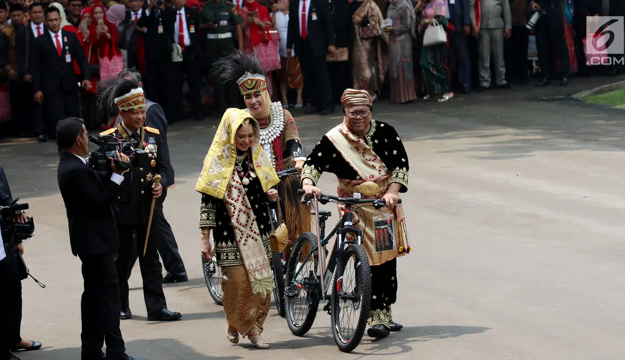 Ketua DPD Oesman Sapta Odang mengenakan kostum adat Minang membawa hadiah sepeda dari Presiden Jokowi usai peringatan HUT RI ke 72 di Istana Merdeka, Jakarta, Kamis (17/8). (Liputan6.com/Pool)