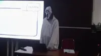 Seorang mahasiswa memakai kostum hantu saat ujian skripsi berlangsung. (dok. Tangkapan layer TikTok @rega_tulusin/https://www.tiktok.com/@rega_tulusin/video/7272739596252007686/Farel Gerald)