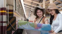 Pelancong wanita dengan peta di stasiun kereta api. (wichayada69@gmail.com/depositphotos.com)