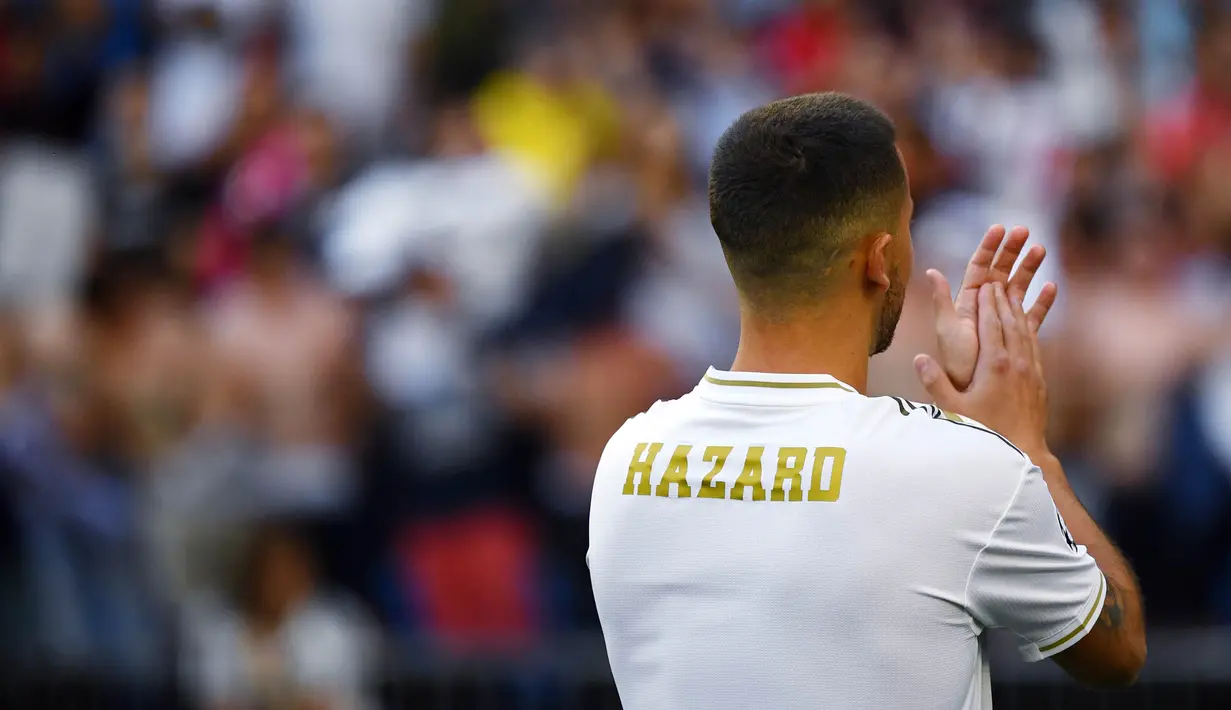 Gelandang Real Madrid, Eden Hazard, menyapa suporter saat perkenalan dirinya di Stadion Santiago Bernabeu, Madrid, Kamis (13/6). Dirinya didatangkan Madrid dari Chelsea dengan kontrak lima musim. (AFP/Gabriel Bouys)