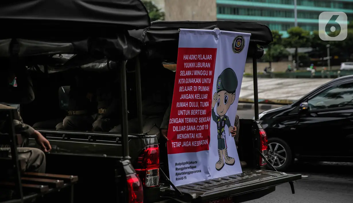 Petugas Satpol PP melakukan sosialisasi kepada masyarakat guna mencegah penularan Covid-19 di Bundaran HI, Jakarta, Kamis (19/3/2020). Sosialisasi yang mengajak masyarakat untuk menerapkan PHBS untuk mengantisipasi penyebaran Covid-19. (Liputan6.com/Faizal Fanani)