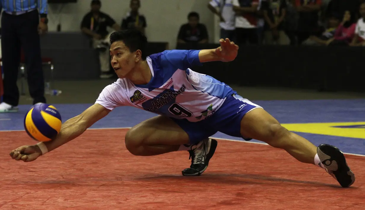 Pemain Jakarta Pertamina Energi, Farhan Halim, menahan bola smes saat melawan Palembang Bank Sumselbabel dalam ajang Proliga 2019 di GOR Among Rogo, Yogyakarta, Minggu (24/12). JPE menang 3-1 atas PBS. (Bola.com/Yoppy Renato)