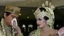 Tiara Dewi membersihkan wajah Lucky Hakim jelang akad nikah di Masjid At Tin, Jakarta, Kamis (19/1). Lucky mengaku deg-degan saat melihat meja akad nikah. (Liputan6.com/Herman Zakharia)