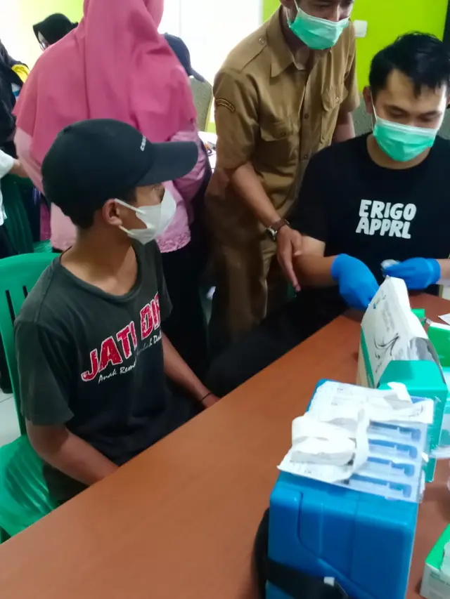 Para peserta vaksinasi nampak antri menunggu giliran program vaksinasi covid-19 di Kecamatan Puspahinga, Kabupaten Tasikmalaya, Jawa Barat.