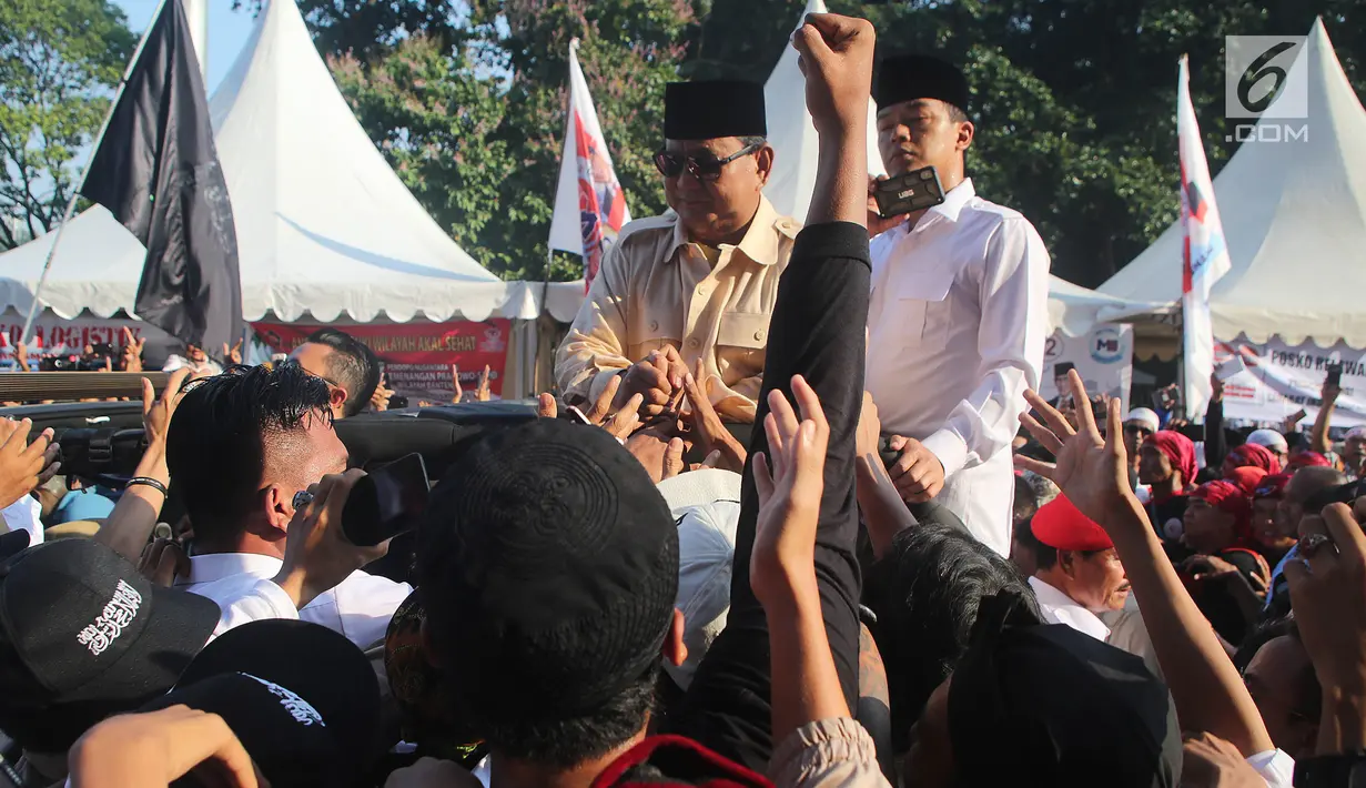 Calon Presiden nomor urut 02 Prabowo Subianto menyapa pendukungnya dalam kampanye akbar Prabowo-Sandi di luar Stadion Utama Gelora Bung Karno, Jakarta, Minggu (7/4/2019). Seperti biasa, Prabowo menyapa pendukungnya dari atas kap mobil. (Liputan6.com/Herman Zakharia)
