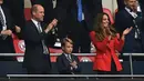 (Kiri ke Kanan) Pangeran William, Duke of Cambridge, Pangeran George dari Cambridge, dan Catherine, Duchess of Cambridge, merayakan gol Inggris ke gawang Jerman pada pertandingan babak 16 besar Euro 2020 di Stadion Wembley, London, Inggris, Selasa (29/6/2021). (Photo by JUSTIN TALLIS/POOL/AFP)