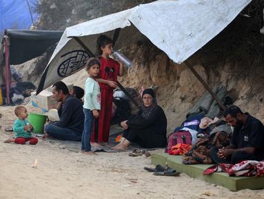 Warga Palestina yang mengungsi dari Kota Gaza berkumpul di bawah naungan tenda-tenda di kamp pengungsi Nuseirat di Jalur Gaza tengah pada 28 September 2025. (Eyad BABA/AFP)