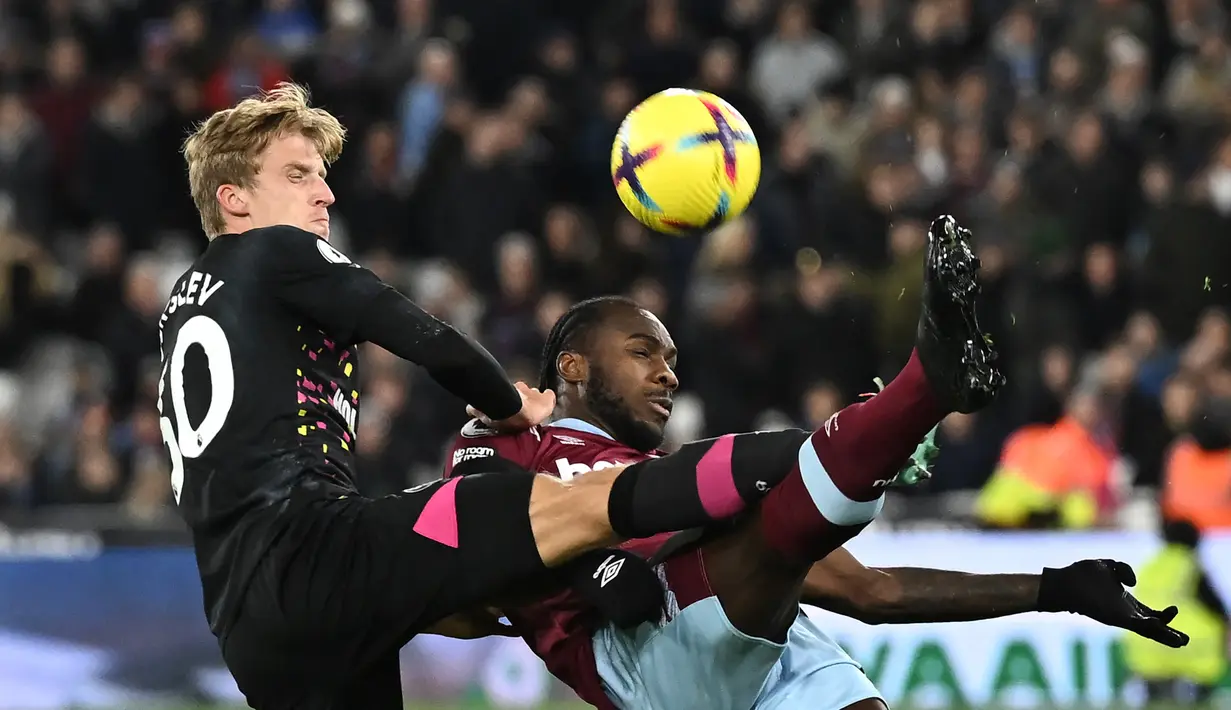 Bek Brentford, Mads Roerslev (kiri) berebut bola dengan gelandang west Ham United, Michail Antonio pada laga Liga Inggris 2022/2023 di London Stadium, London (30/12/2022). Mads Roerslev didatangkan dari FC Copenhagen pada awal musim 2019/2020 saat Brentford masih berkompetisi di Championship. Musim 2022/2023 ini ia telah tampil dalam 15 laga di Liga Inggris. (AFP/Ben Stansall)