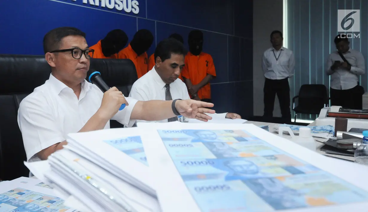 Direktur Tindak Pidana Ekonomi dan Khusus Bareskrim Polri Brigjen Pol Agung Setya (kiri) memberi keterangan terkait pengungkapan peredaran uang palsu pecahan Rp 50.000,- emisi tahun 2016 saat rilis di Jakarta (29/1). (Liputan6.com/Helmi Fithriansyah)