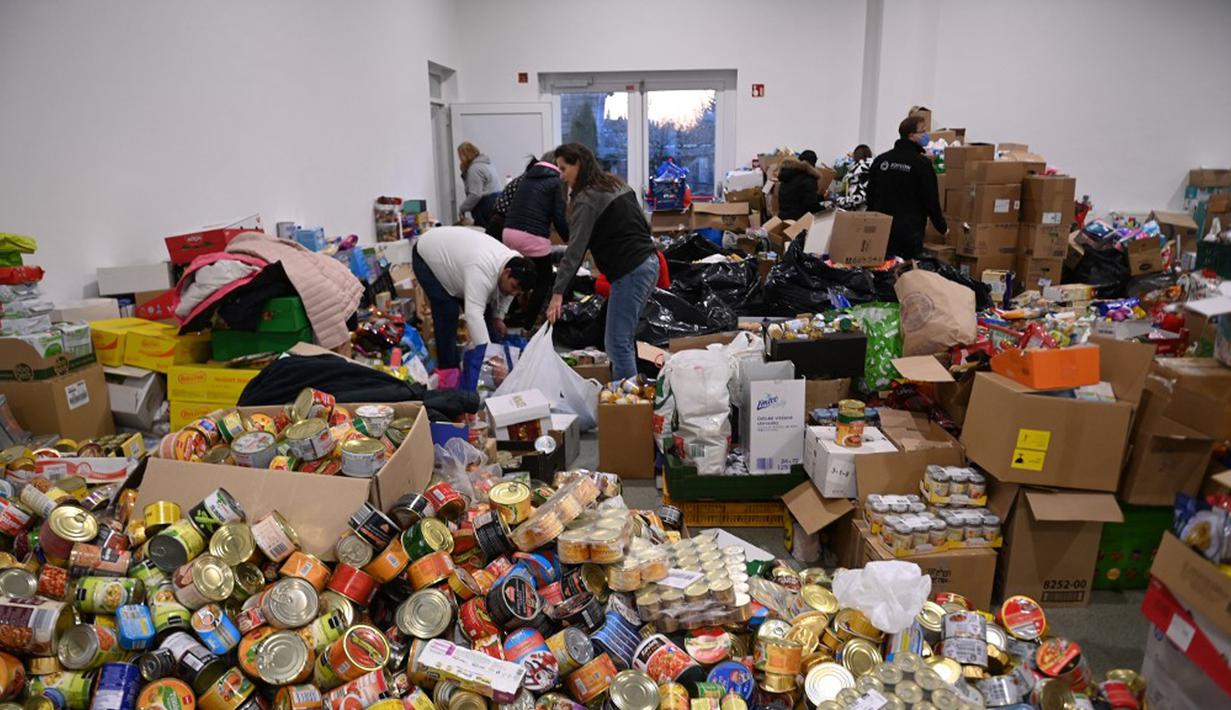 Relawan menyiapkan sumbangan di pusat pengungsi sementara di sekolah dasar setempat di Tiszabecs, Hongaria timur, 28 Februari 2022. Warga Hungaria bergegas ke perbatasan Ukraina untuk membantu pengungsi yang melarikan diri dari invasi Rusia. (Attila KISBENEDEK/AFP)