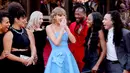 Dilansir dari ET, Taylor Swift tiba pada acara tersebut mengenakan sebuah gaun biru yang didesain oleh Oscar De La Renta. Rambutnya yang panjang ditata menjadi lebih pendek ala vintage. (Matt Winkelmeyer/Getty Images/AFP)