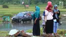 Warga berselfie dengan latar belakang kawasan terdampak bencana tsunami di Carita, Banten, Selasa (25/12). Libur Natal dimanfaatkan warga luar Anyer dan carita untuk menyaksikan langsung terdampak bencana sambil berselfie. (Merdeka.com/Arie Basuki)