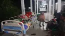 Warga berlindung di luar ruangan rumah sakit setelah gempa mengguncang Desa Muara Sikabaluan, Pulau Siberut, Kabupaten Kepulauan Mentawai, Provinsi Sumatra Barat, Selasa (25/4/2023) dini hari. Badan Meteorologi Klimatologi dan Geofisika (BMKG) memutakhirkan kekuatan gempa Kepulauan Mentawai yang sebelumnya magnitudo 7,3 menjadi magnitudo 6,9. (BAMBANG SAGURUNG/AFP)