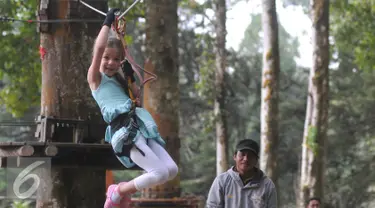 Isabella Damla Guvenilir peran utama di serial Elif sedang mencoba Flying Fox di wahana Bali Treetop Adventur Park, Bali, Rabu (26/8/2015). Isabella mengaku senang dengan aneka permainan yang dicobanya. (Liputan6.com/Herman Zakharia)