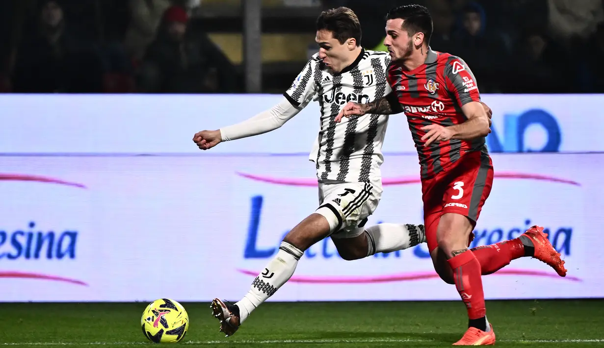 <p>Penyerang Juventus, Federico Chiesa berusaha melewati bek Cremonese, Emanuele Valeri selama pertandingan lanjutan Liga Serie A Italia di Zini Stadium, Cremona, Italia, Kamis (4/1/2023). Juventus menang tipis atas Cremonese dengan skor 1-0. (AFP/Marco Bertorello)</p>