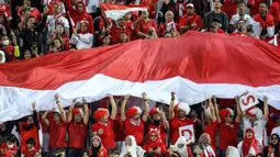 Para suporter Indonesia memberi dukungan saat Timnas Indonesia U-23 menghadapi Irak U-23 pada laga perebutan tempat ketiga Piala Asia U-23 2024 di Abdullah bin Khalifa Stadium, Doha, Qatar, Kamis (2/5/2024). (AFP/Karim Jaafar)
