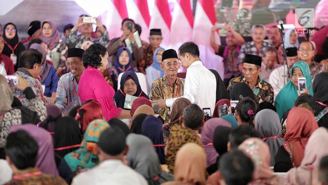 Presiden Joko Widodo menyerahkan sertifikat tanah kepada warga di Pusat Penerbangan Angkatan Darat, Pondok Cabe,  Tangerang Selatan, Jumat (25/1). Pada kesempatan ini, 40.172 sertifikat tanah dibagikan oleh Jokowi (Liputan6.com/Faizal Fanani)