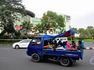 Di Jalan Raya Bogor, Jakarta, sejumlah warga menggunakan mobil bak terbuka untuk bersilaturahmi, Kamis (31/7/14). (Liputan6.com/Faizal Fanani)