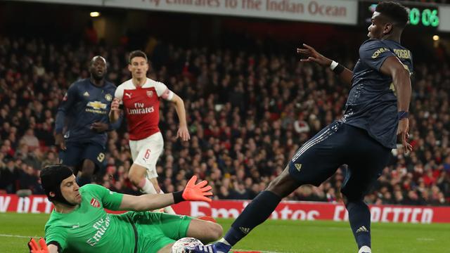 Gelandang Manchester United, Paul Pogba, berusaha melewati kiper Arsenal, Petr Cech. (AFP/Daniel Leal-Olivas)