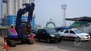 Pekerja dibantu alat berat menyelesaikan proyek pembangunan Mass Rapid Transit (MRT) di kawasan Lebak Bulus, Jakarta, Senin (23/3/2015). Rencananya, pembangunan koridor tersebut ditargetkan selesai pada Mei 2016. (Liputan6.com/Yoppy Renato)