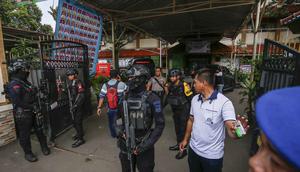 Petugas tim penjinak bom berjaga di pintu masuk SMAN 72 Jakarta pada 7 November 2025. Sebuah ledakan terjadi di SMAN 72 Jakarta di kawasan Kecamatan Kelapa Gading, Jakarta Utara, pada Jumat 7 November 2025 siang. (CANDRA/AFP)