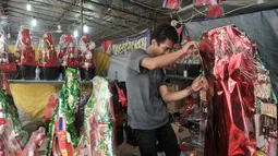 Pedagang parcel merapihkan barang dagangannya di kawasa Cikini, Jakarta, Jumat (16/12). Jelang hari raya Natal, penjualan parcel di kawasan Cikini masih sepi pemebeli. (Liputan6.com/Yoppy Renato)