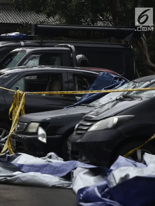 Kondisi mobil yang terparkir di halaman Mapolsek Ciracas, Jakarta, Rabu (12/12). Mobil yang dirusak saat penyerangan Polsek Ciracas di antaranya mobil polisi dan mobil Puspom Kodam. (Liputan6.com/Herman Zakharia)