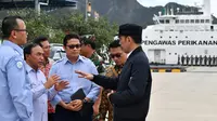 Presiden Joko Widodo (kanan) berbincang dengan para pejabat saat melakukan kunjungan kerja di Sentra Kelautan Perikanan Terpadu (SKPT), Natuna, Kepulauan Riau, Rabu (8/1/2020). Kunjungan Jokowi tersebut pascakapal coast guard milik China berlayar di perainan laut Natuna. (HO/PRESIDENTIAL PALACE/AFP)