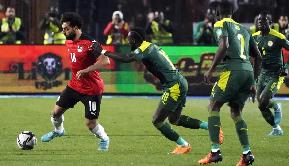 Pemain Senegal Sadio Mane mencoba mengejar pemain Mesir Mohamed Salah (kiri) pada pertandingan kualifikasi Piala Dunia 2022 di Stadion Internasional Kairo, Kairo, Mesir, 25 Maret 2022. Mesir menang 1-0. (AP Photo/Amr Nabil)