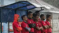 Para pemain Persija Jakarta berteduh dari hujan saat latihan di Lapangan Sutasoma, Jakarta, Rabu (31/1/2018). Latihan ini merupakan persiapan jelang babak delapan besar Piala Presiden. (Bola.com/Asprilla Dwi Adha)