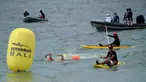 Para peserta bertanding sambil ditonton oleh kru pendukung dalam kompetisi renang Oceanman Bali 2021 di sebuah pantai di Sanur, Denpasar, Bali, Sabtu (18/9/2021). Oceanman Bali 2021 akhirnya sukses digelar setelah beberapa kali ditunda. (SONY TUMBELAKA/AFP)