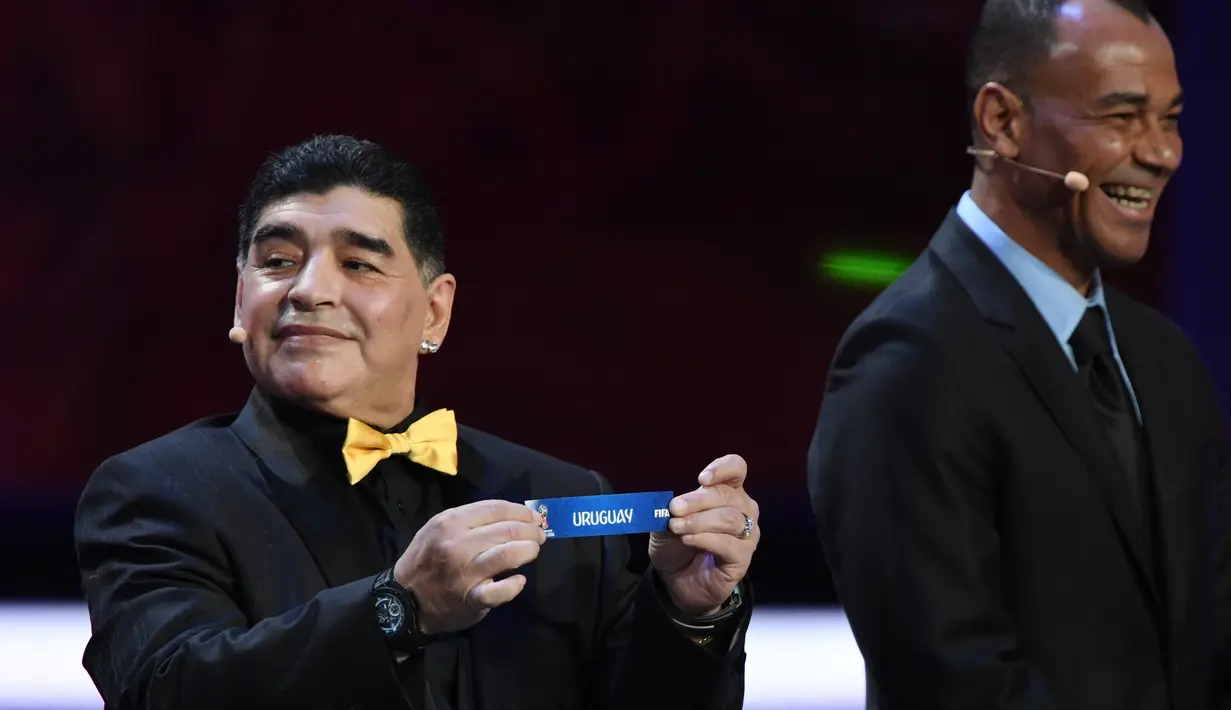Legenda sepak bola dunia, Diego Maradona dan Cafu (kanan) saat undian Piala Dunia 2018 di State Kremlin Palace, Moscow, (1/12/2017). Piala Dunia 2018 dimulai sejak 14 Juni-15 Juli 2018 di Rusia. (AFP/Yuri Kadobnov)