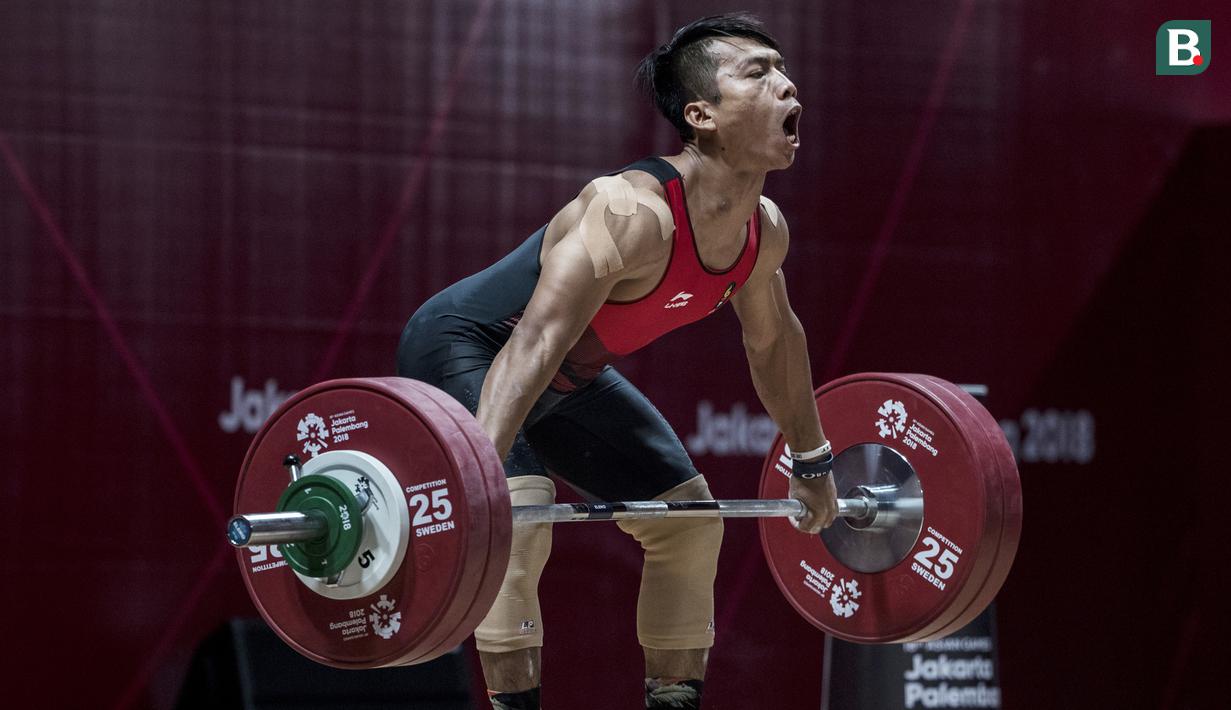 Lifter Indonesia, Deni, saat berlaga pada Asian Games di JIExpo, Jakarta, Rabu, (22/8/2018). Deni memastikan lolos ke final setelah berhasil membukukan poin terbaik dengan total angkatan seberat 318 kg. (Bola.com/Vitalis Yogi Trisna)