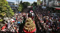 Ribuan warga berkumpul saat kendaraan hias yang ditumpangi Presiden Joko Widodo (Jokowi) dan Ibu Negara, Iriana Joko Widodo selama Karnaval Kemerdekaan Pesona Parahyangan 2017 melintas di pusat Kota Bandung, Sabtu (26/8). (Liputan6.com/Johan Tallo)