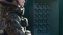 Tentara Korsel berjaga di dekat pengeras suara yang dipasang di sebelah selatan zona demiliterisasi, Yeoncheon, Jumat (8/1/2016). Pengeras suara tersebut memasang musik pop Korea, berita dan kritik atas Korea Utara ke arah perbatasan. (YONHAP/AFP)