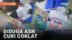 Pencurian kembali terjadi di minimarket, melibatkan pria diduga ASN. Pelaku pria berbaju putih dengan pin awalnya berbincang dengan kasir usai membayar. Saat kasir dan pengunjung lengah, pelaku mengambil coklat dari rak.