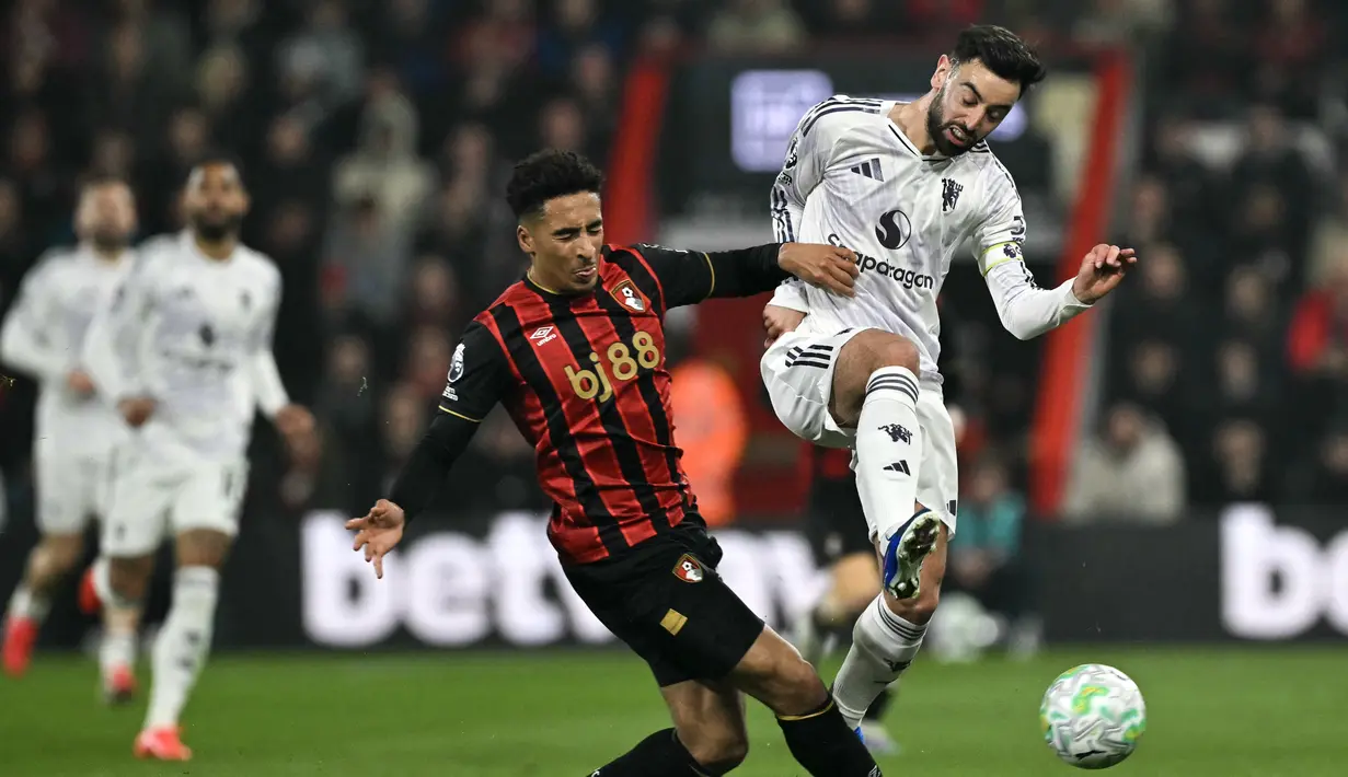 Pemain Manchester United, Bruno Fernandes berduel dengan pemain Bournemouth pada pertandingan pekan ke-31 Liga Inggris 2025/2026 di Vitality Stadium, Sabtu (21/03/2026) dini hari WIB. (AFP/Glyn Kirk)