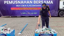 Barang-barang tersebut terdiri dari 41,5 juta batang hasil tembakau ilegal, termasuk 33,2 juta batang milik Bea Cukai dan 8,3 juta batang hasil penindakan Kejaksaan, serta 940,89 liter minuman mengandung etil alkohol (MMEA), 10 ribu gram tembakau iris, dan sejumlah barang bukti elektronik. Tampak dalam foto, petugas melakukan pemusnahan barang ilegal hasil penindakan di bidang kepabeanan dan cukai di ICE BSD City, Tangerang, Rabu (12/11/2025). (merdeka.com/Arie Basuki)