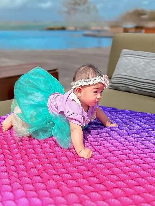 Penampilannya itu kompak dengan sang buah hati yang tampil imut mengenakan dress bernuansa biru dan pink ala Princess Ariel. @riaricis1795.