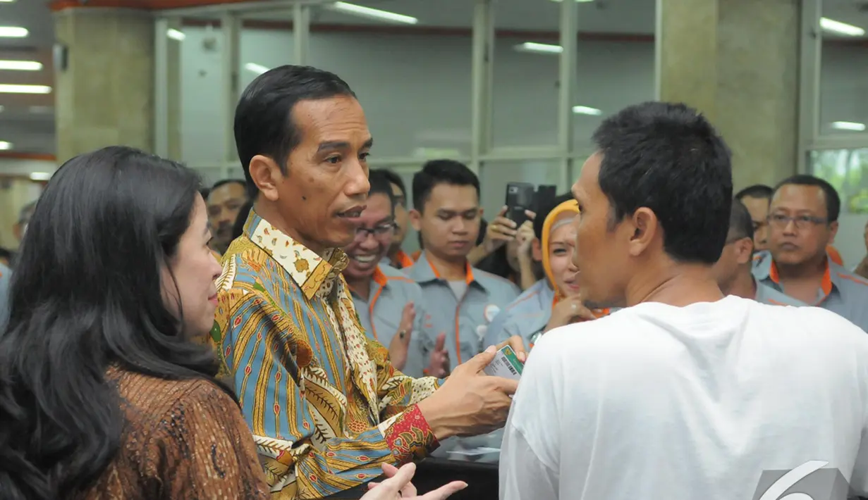 Presiden Jokowi berdialog dengan seorang warga yang mengantre untuk mendapatkan Kartu Indonesia Sehat di Kantor Pos Pasar Baru, Jakarta, Senin (3/11/2014). (Liputan6.com/Herman Zakharia)