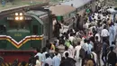 Warga Pakistan menaiki kereta api ke kampung halaman untuk merayakan Idul Adha, atau "Hari Raya Kurban," di Lahore, Pakistan, Kamis (7/7/2022). Selama hari raya, yang di sebagian besar tempat berlangsung selama empat hari, umat Islam menyembelih domba atau sapi dan membagikan sebagian dagingnya kepada orang miskin. (AFP/Arif Ali)