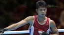 Petinju Indonesia, Grece Savon Simangunsong merayakan kemanangan atas Hiroaki Kinjo pada semifinal Test Event Asian Games 2018 kelas Welter di Kemayoran, Jakarta (14/2/2018). Simangunsong menang dengan skor 3-2. (Bola.com/Nick Hanoatubun)