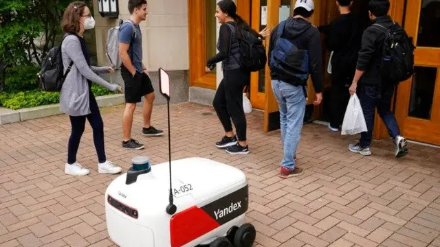 Robot pengantar makanan melintasi jalan di Ann Arbor, Michigan pada Kamis, 7 Oktober 2021. (Foto: AP/Carlos Osorio)