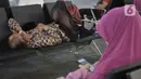 Calon Jemaah umrah menunggu kepastian di Terminal 3 Bandara Soekarno Hatta, Tangerang, Kamis (27/2/2020). Calon Jemaah umrah tertahan di Terminal 3 Soetta, buntut dari kebijakan Kerajaan Arab Saudi menyetop pelayanan visa umrah guna mencegah penyebaran virus corona. (merdeka.com/Iqbal Nugroho)