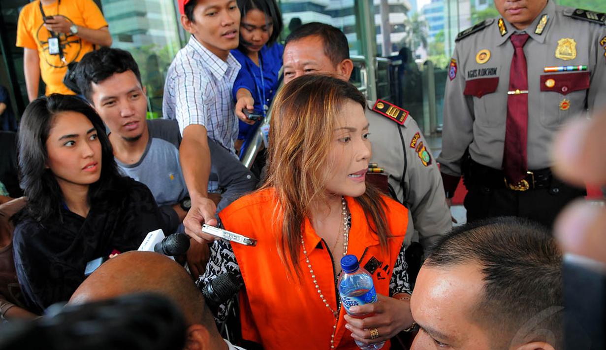 Wanita berambut pirang itu tampak mengenakan rompi tahanan berwarna oranye saat mendatangi gedung KPK, Jakarta, Rabu (13/8/14). (Liputan6.com/Faisal R Syam)