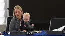 Anggota Parlemen Eropa asal Swedia, Jytte Guteland membawa bayinya saat ikut ambil bagian dalam pengambilan suara di Parlemen Eropa di Strasbourg, Prancis, (14/3). (AFP Photo / Frederick Florin)