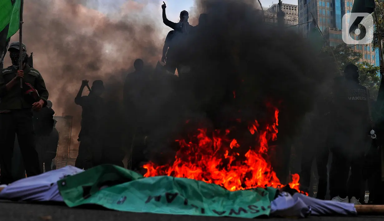 Dalam kerumunan massa terlihat asap hitam bekas ban terbakar saat aksi unjuk rasa atau demo BBM naik di kawasan Patung Kuda, Jakarta, Senin (5/9/2022). Dalam aksi ini, para mahasiswa tersebut mendesak Presiden Jokowi untuk menurunkan harga BBM bersubsidi, yang baru saja naik pada akhir pekan lalu. (Liputan6.com/Angga Yuniar)