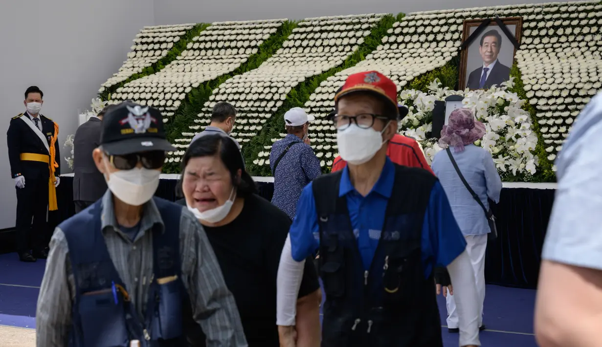 Para pelayat memberikan penghormatan mereka di sebuah altar peringatan untuk almarhum Wali Kota Seoul Park Won-soon di Seoul City Hall Plaza, Sabtu (11/7/2020). Kematian mendadak Wali Kota Seoul, yang dilaporkan terlibat dalam tuduhan pelecehan seksual, menjadi sorotan publik. (Ed JONES / AFP)