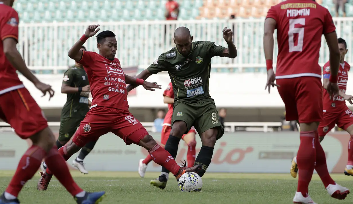 Striker PS Tira Persikabo, Loris Arnaud, berebut bola dengan pemain Persija Jakarta pada laga Shopee Liga 1 di Stadion Pakansari, Bogor, Selasa (16/7). Tira menang 5-3 atas Persija. (Bola.com/Yoppy Renato)