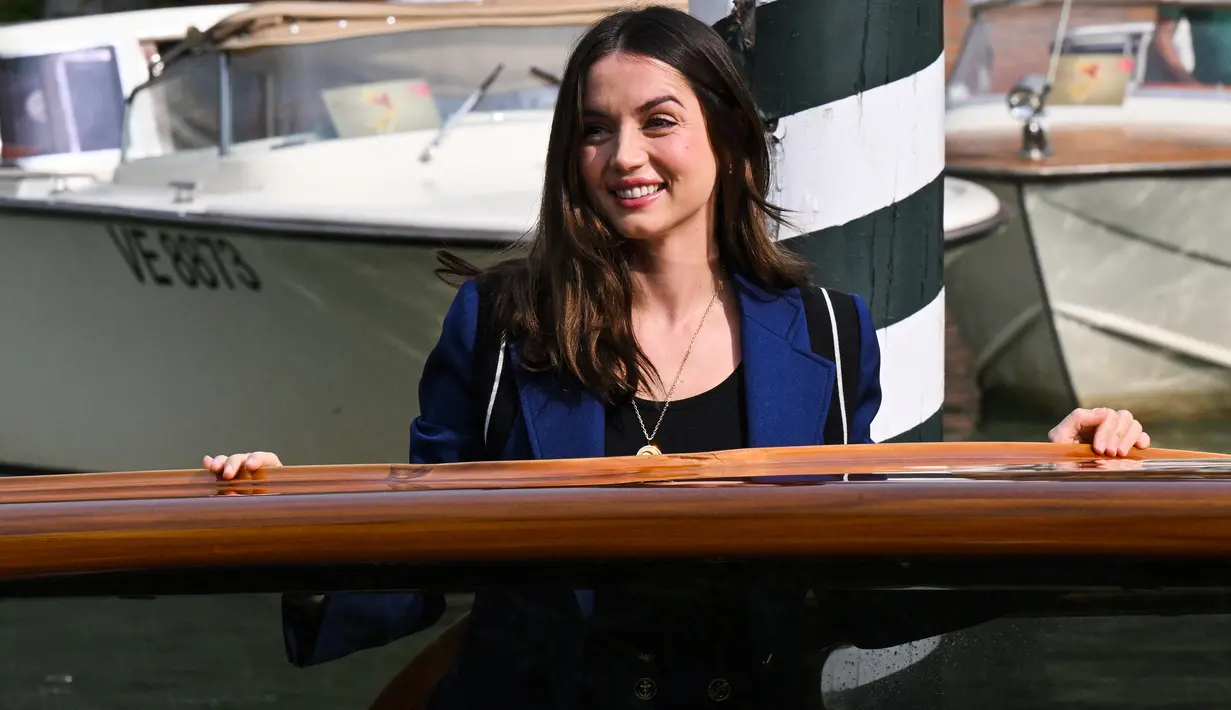 Ana de Armas tersenyum saat tiba di dermaga Hotel Excelsior selama Venice Film Festival 2022 ke-79 di Lido di Venesia, Italia pada 7 September 2022. Aktris Spanyol Kuba ini tampil memukau dengan celana pendek biru tua dan jaket yang serasi. (AFP/Tiziana Fabi)